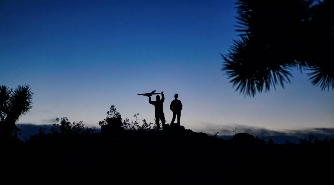 Father and son on horizon playing with drone