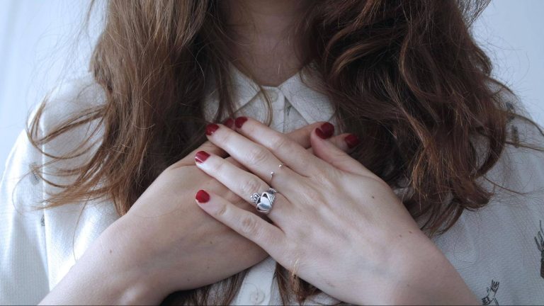 woman_with_hands_over_heart
